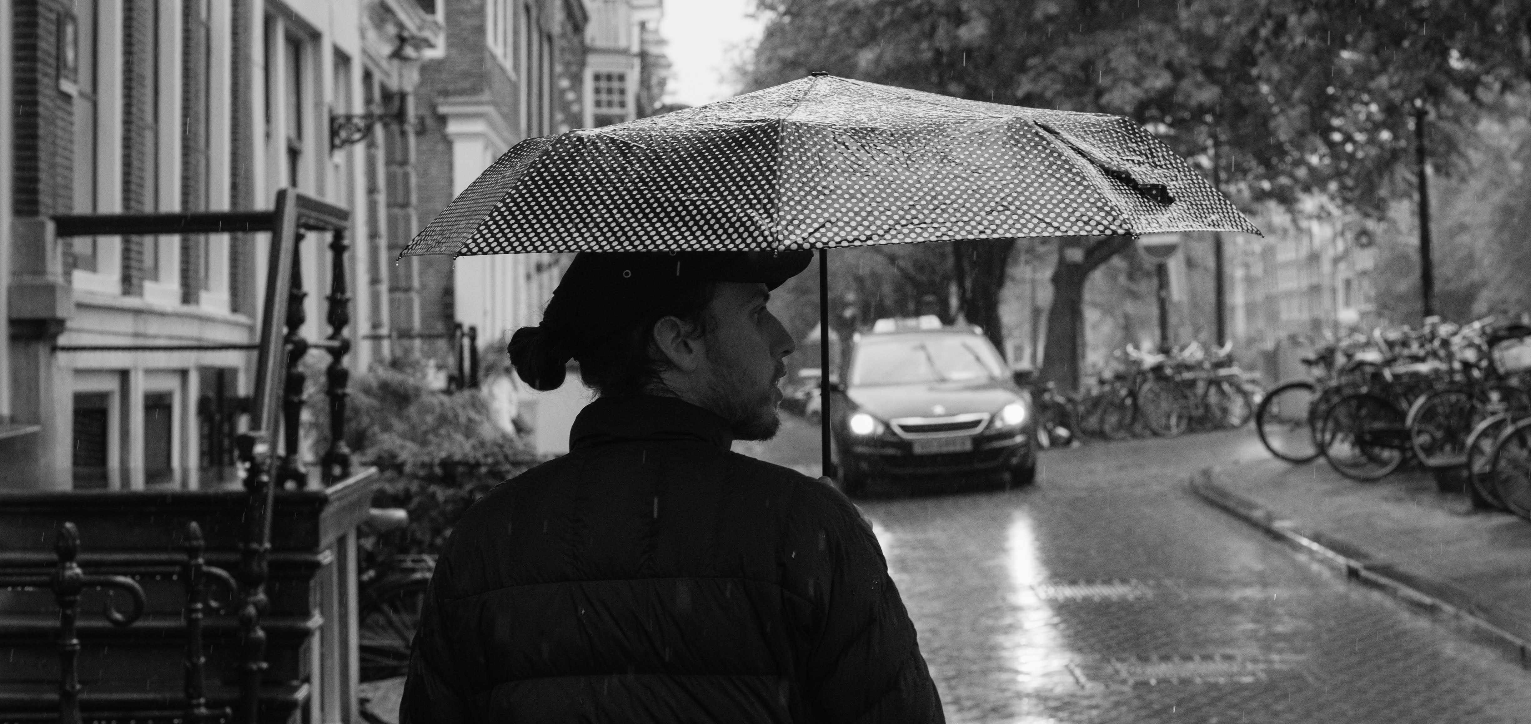 Large photo of Tom holding an umbrella